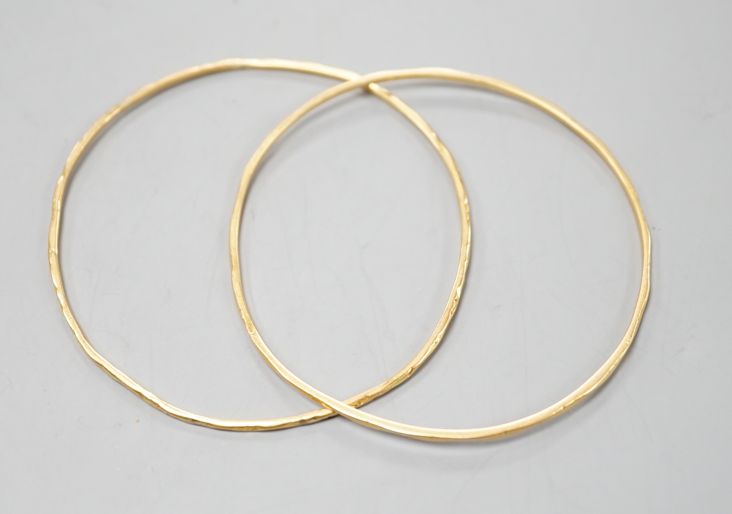 A pair of yellow metal child's bangles, diameter 58mm, 8.9 grams.